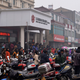 People gather in front of a branch of Jiangsu Sheyang Rural Commercial Bank, in Yancheng, Jiangsu province.